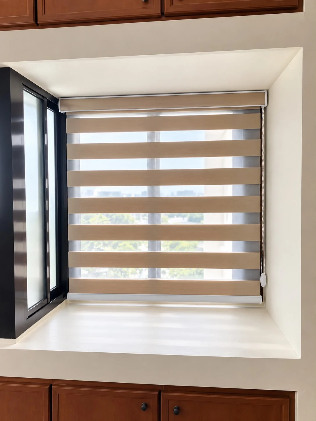 A beige combi blind with alternating sheer bands inside a recessed window